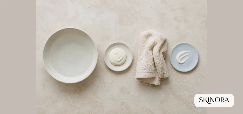 Minimal gentle-cleansing routine with water, soft towel, cleanser and moisturiser