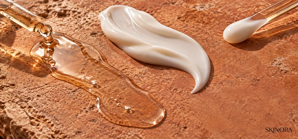Text-free macro comparison of a lightweight body serum trail and an opaque lotion ribbon