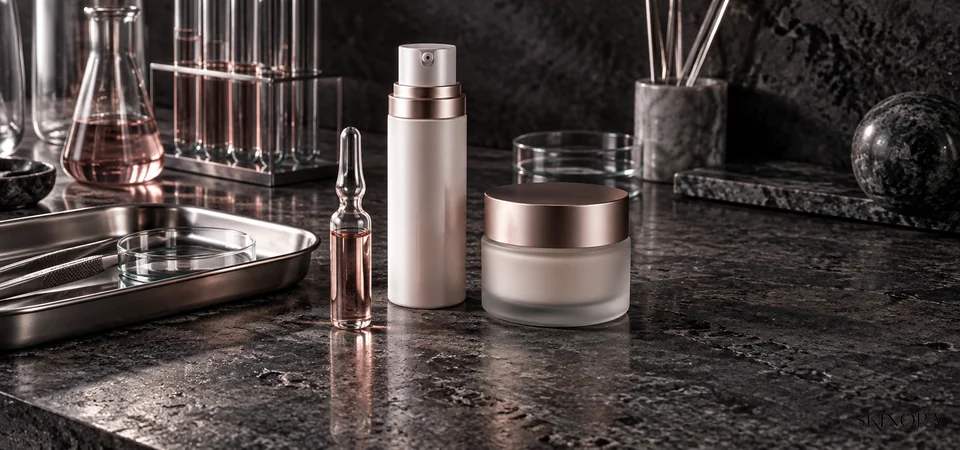 Unbranded ampoule, airless pump and jar arranged for an exosome skincare product check